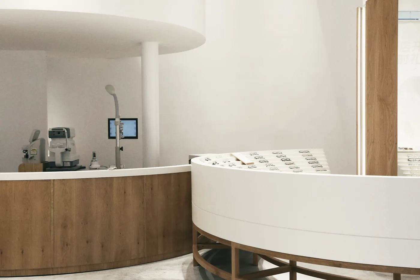 A curved white reception desk in a bright modern clinic