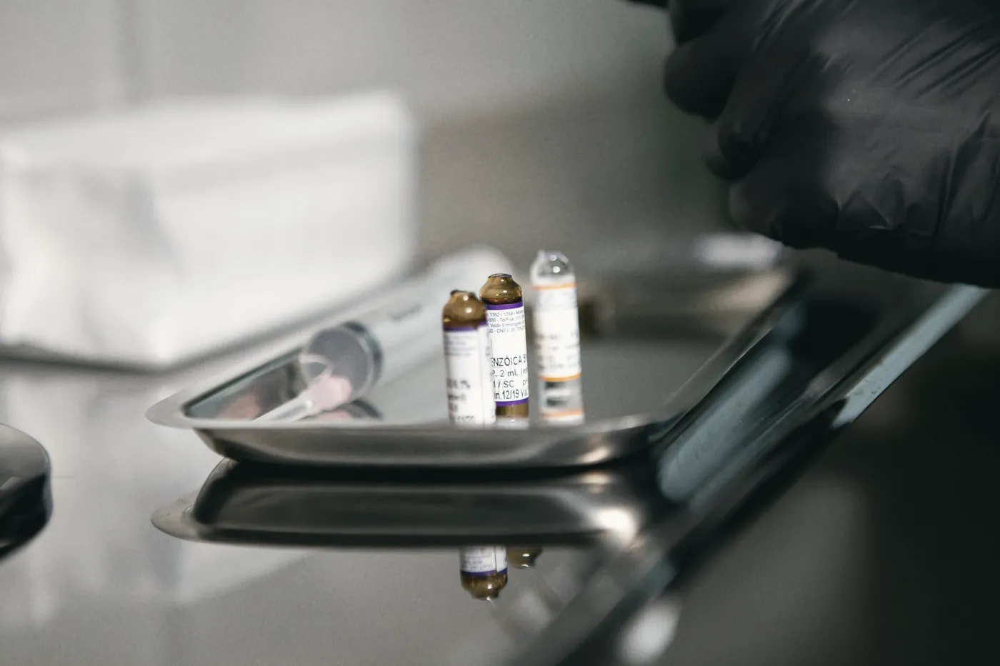 Small medicine vials on a metal clinic tray