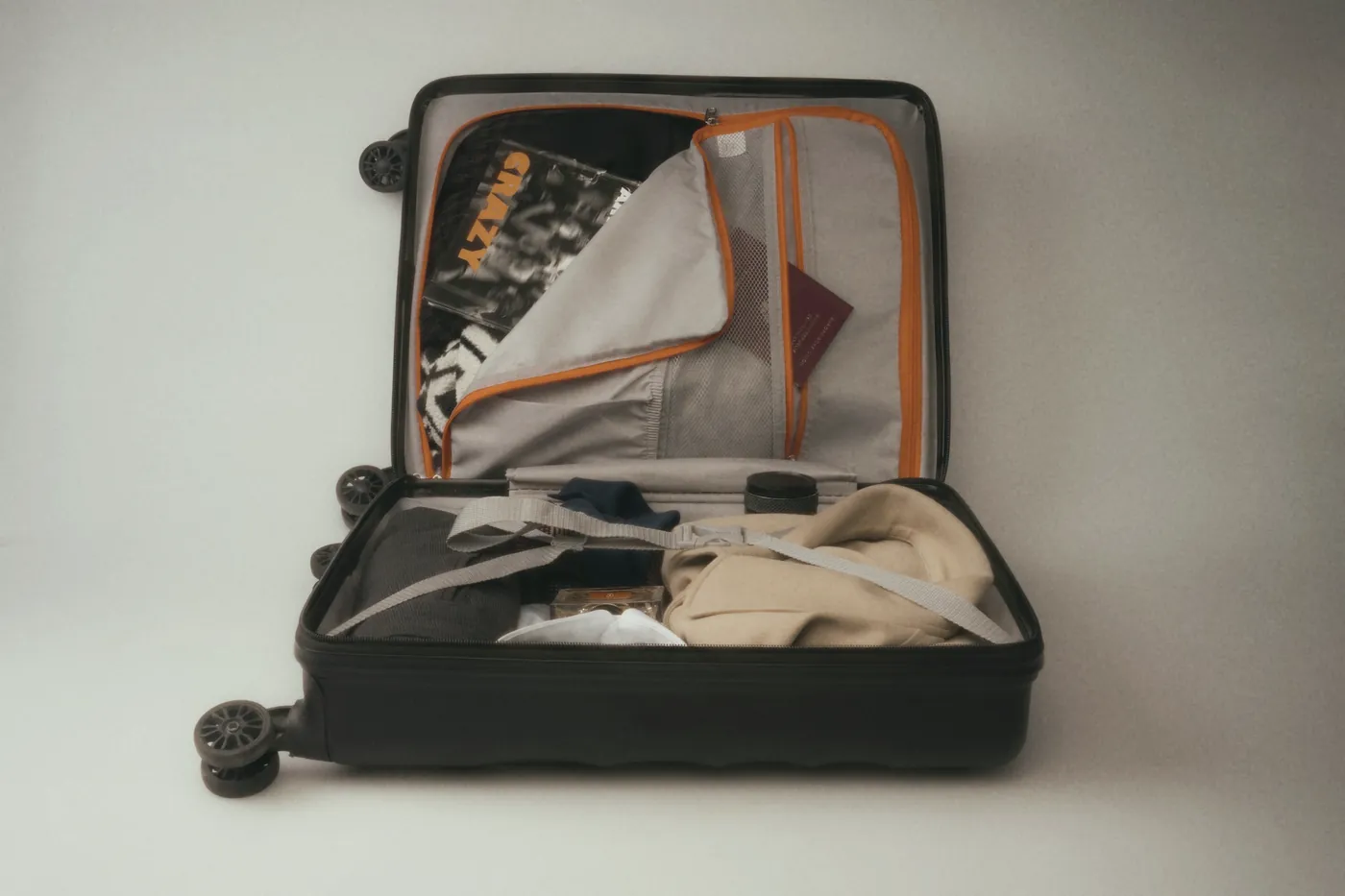An open suitcase with folded clothes inside