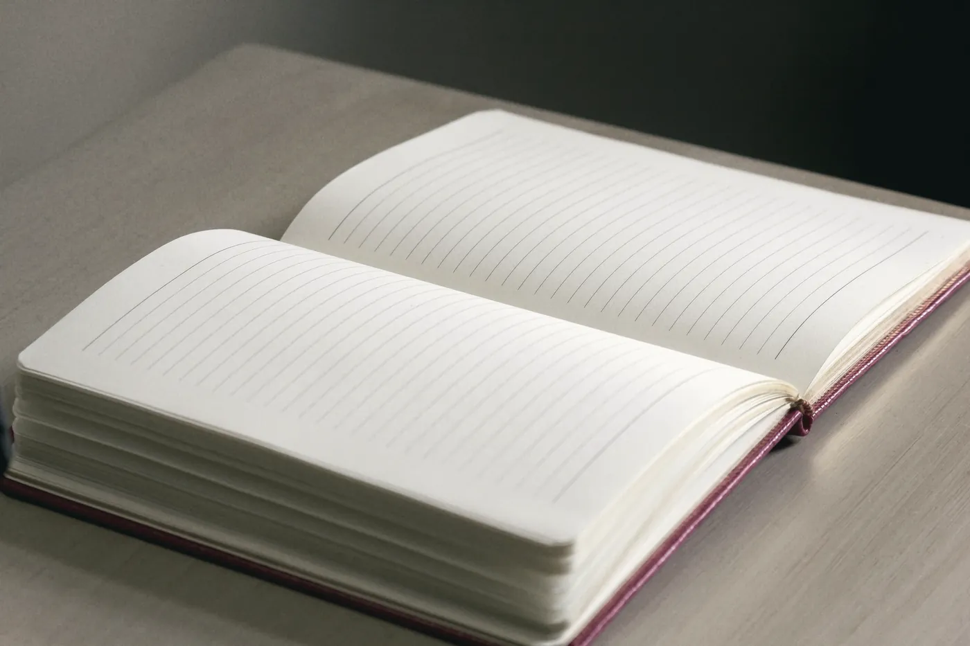 An open notebook with blank pages on a table