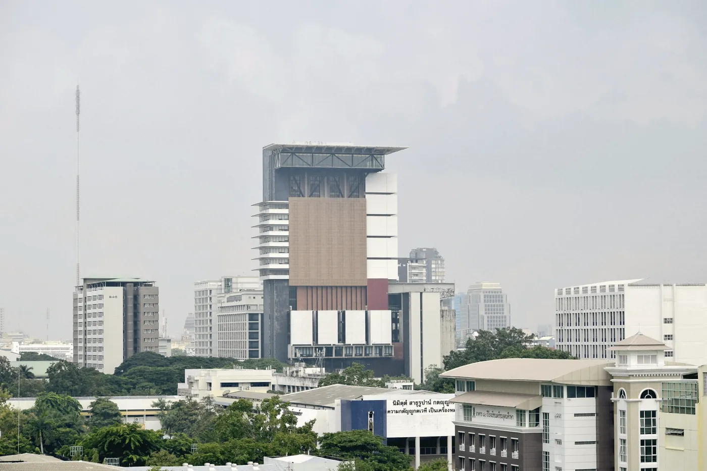 A modern building against a cloudy Bangkok sky